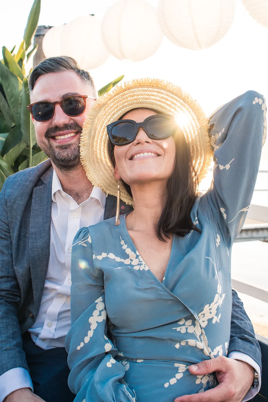 Happy couple in sunglasses smiling in the sun